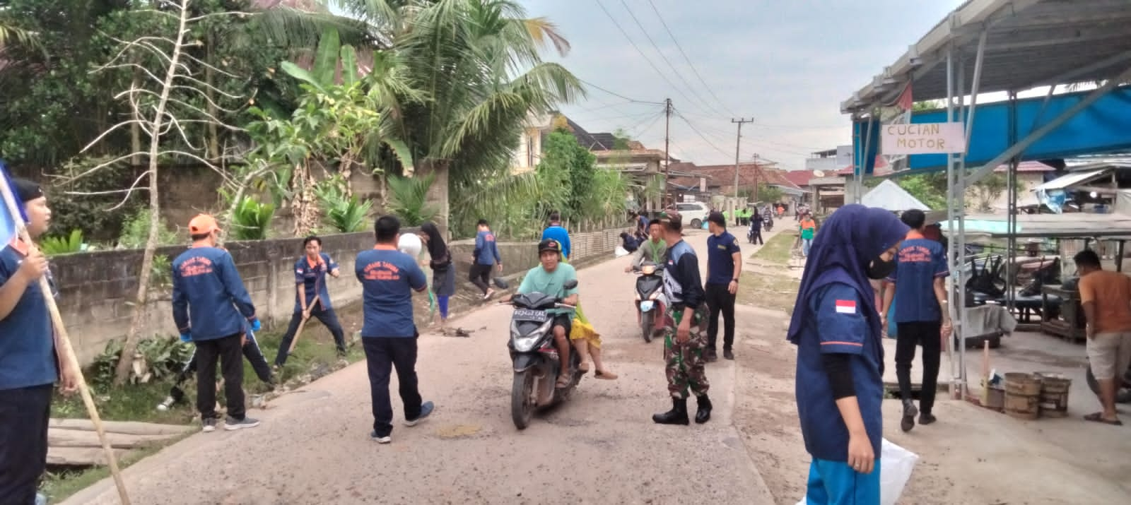 Kolaborasi Babinsa dengan Karang Taruna Desa Tulung Selatan, Bersihkan Parit Jalan